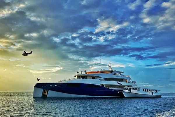 Luxury and budget liveaboard boats in the Maldives, showing divers enjoying crystal-clear waters, coral reefs, and tropical marine life.