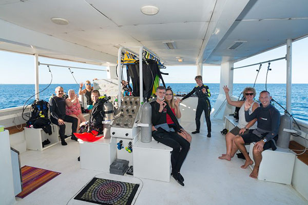 Diver packing gear and essentials for a liveaboard trip in Saudi Arabia’s Red Sea, including dive equipment, clothing, and accessories.