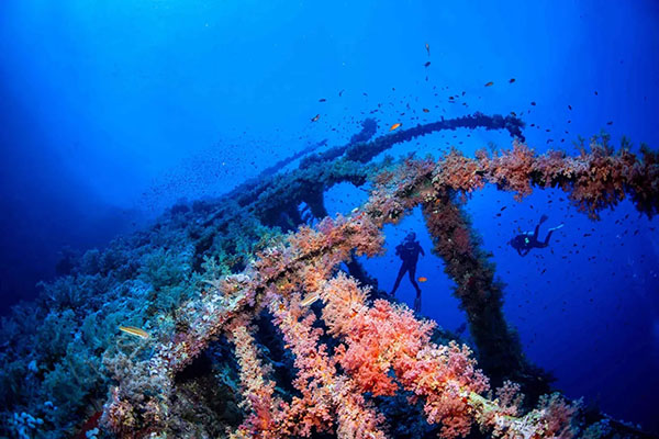 Divers relaxing on the deck of a Red Sea liveaboard yacht in Egypt after a day of scuba diving.